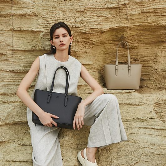 Structured everyday tote bag in premium synthetic leather, carried in soft daylight