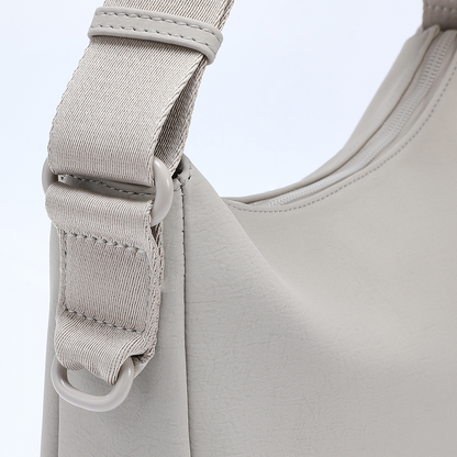 Detailed close-up of ACACIA Clover strap and hardware. Premium PU leather, reinforced stitching, color-matched metalwork, and charm loop. Perfect Uniqlo-style minimalist belt bag for women.