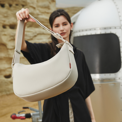 Close-up of the ACACIA Clover belt bag showing smooth PU leather, charm loop, and signature burgundy lining. Minimalist Uniqlo-style women’s crossbody and waist bag.