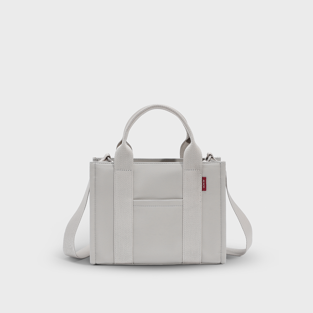 ACACIA Fern Mini Tote Bag in premium leather-feel PU, structured silhouette, water-repellent finish, and minimalist design. Compact but fits 11-inch tablet, with crossbody strap, burgundy lining, and color-matched hardware. Urban Uniqlo-style small tote.