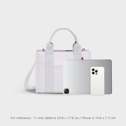 Size reference for the ACACIA Fern Mini Tote in ice purple showing perfect fit for 11-inch tablet. Premium PU leather feel, structured body, lightweight, and water-repellent. Minimalist urban tote with removable crossbody strap.