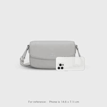 Size comparison of the IVY unisex crossbody bag showing compact fit for phone and essentials. Magnetic flap and hidden zipper provide double protection. A premium vegan leather sling bag for both men and women.
