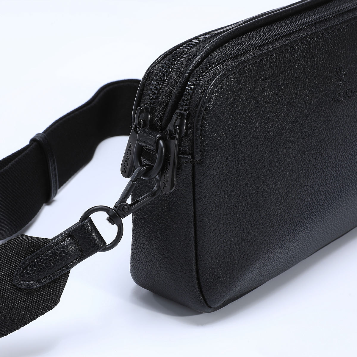 Close-up of ACACIA Moss vegan leather crossbody bag showing soft premium texture, reinforced stitching, and durable double zippers. Compact unisex sling for daily essentials.