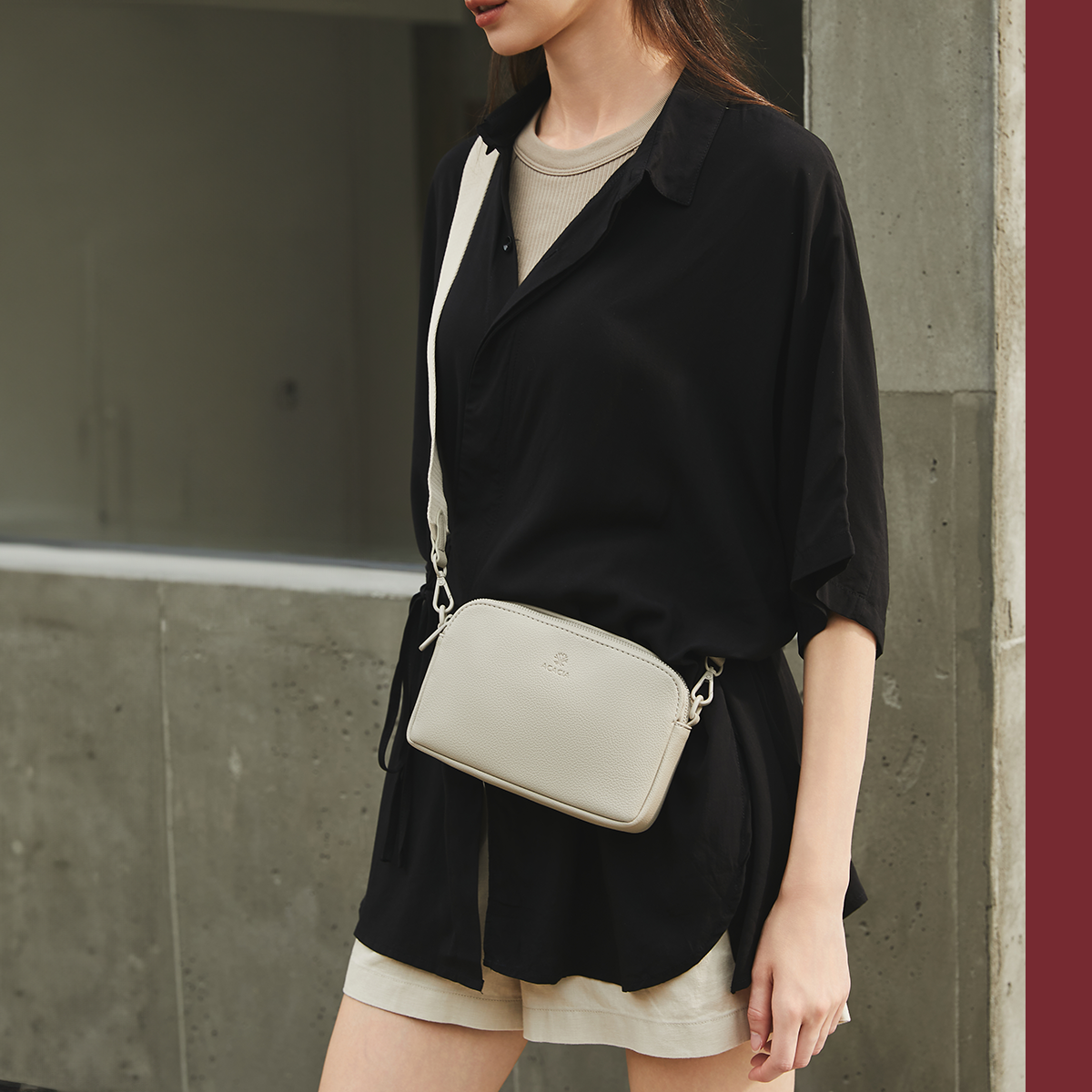 Light beige ACACIA Moss unisex crossbody bag in soft vegan leather. Features wide comfortable strap and double-zip compartments for daily essentials.