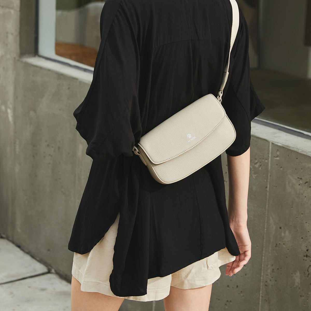 Close-up of the ACACIA IVY unisex sling bag in soft vegan leather. Magnetic flap and hidden zipper provide double protection. A lightweight crossbody for men and women.