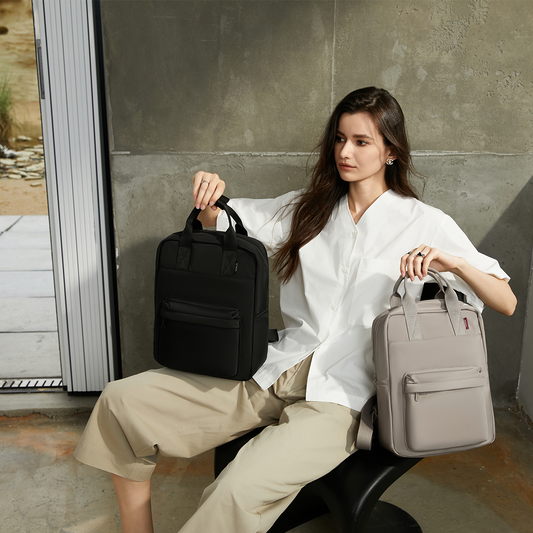 Lifestyle view of the unisex Reed Backpack in both black and beige. A lightweight compact backpack ideal for students, commuters, and young adults seeking a stylish everyday laptop bag.