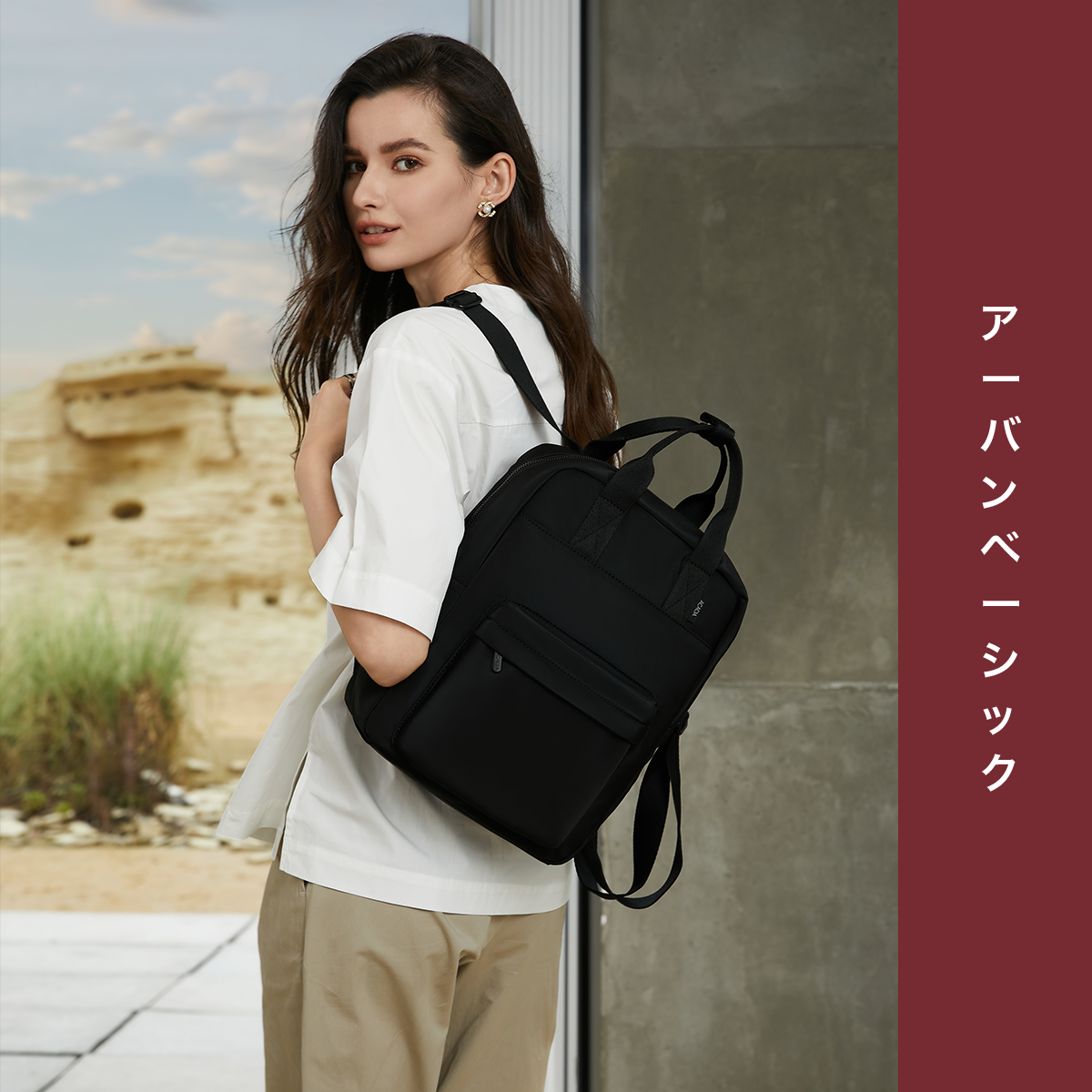 Model wearing the Reed Backpack in black. A unisex compact daypack designed for laptops, school essentials, and everyday carry. Lightweight and perfect for modern minimalist style.